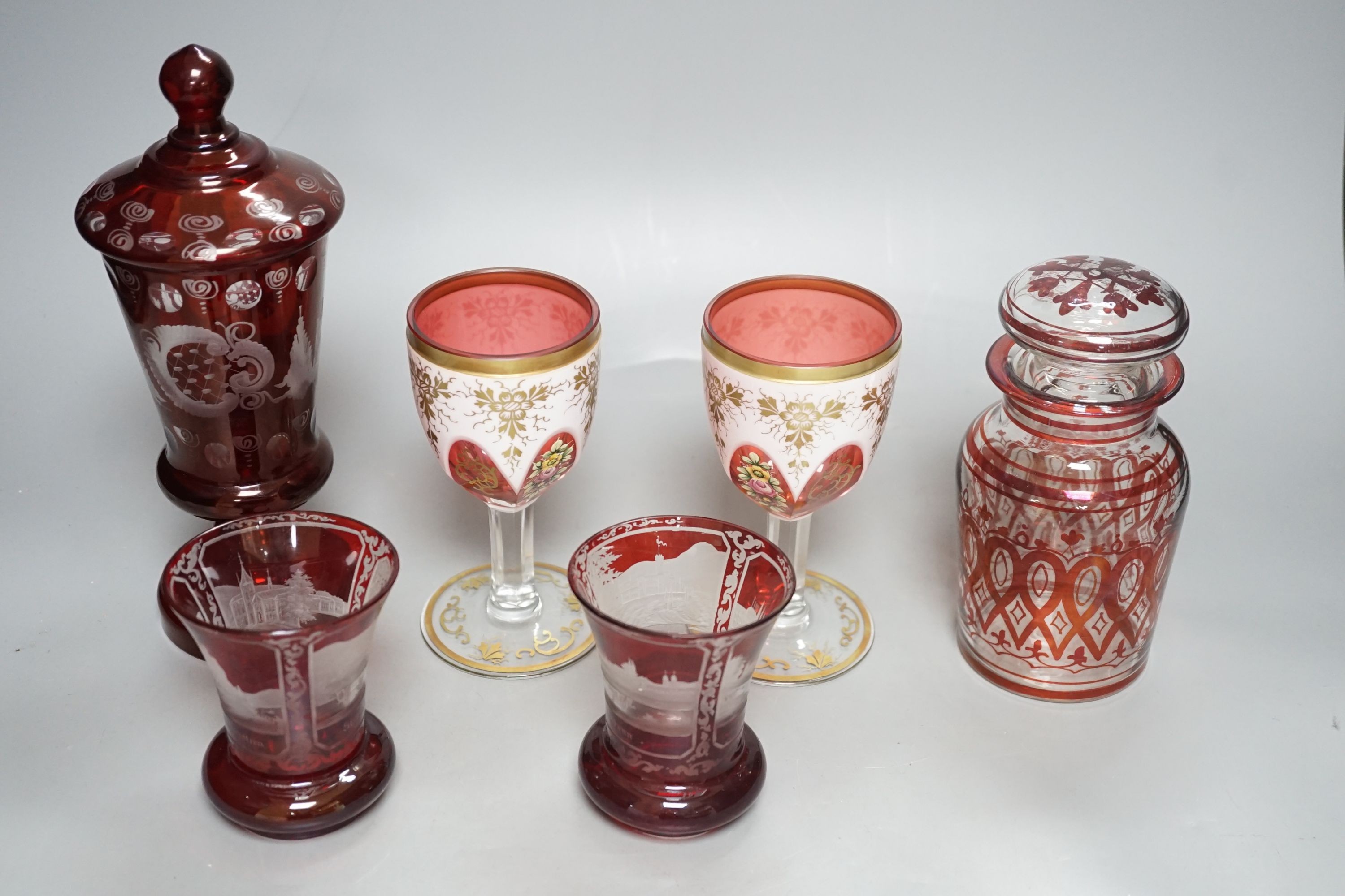 A pair of 19th century Bohemian ruby overlaid wine glasses, possibly Moser and other bohemian ruby glasswares
